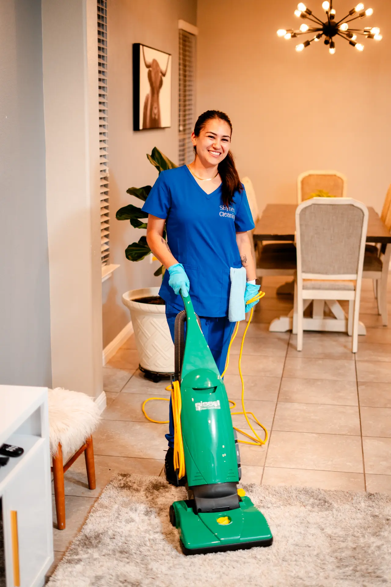 Shynex cleaner smiling with vacuum
